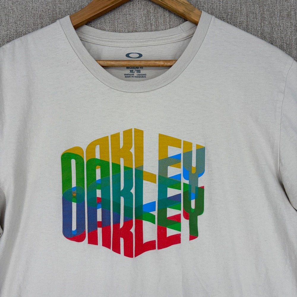 Oakley‎ T-Shirt Mens XL Cream Multi-Color Stacked Logo Graphic Short Sleeve Tee